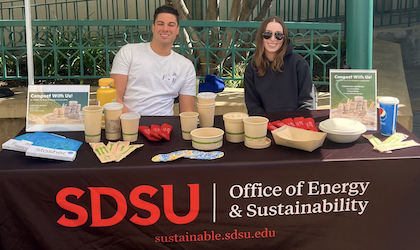 Student Assistants tabling outside Charles B. Bell Jr. Pavillion with an array of compostable dining materials